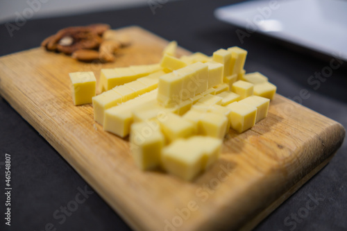 Fresh diced cheese and walnuts on a cutting board