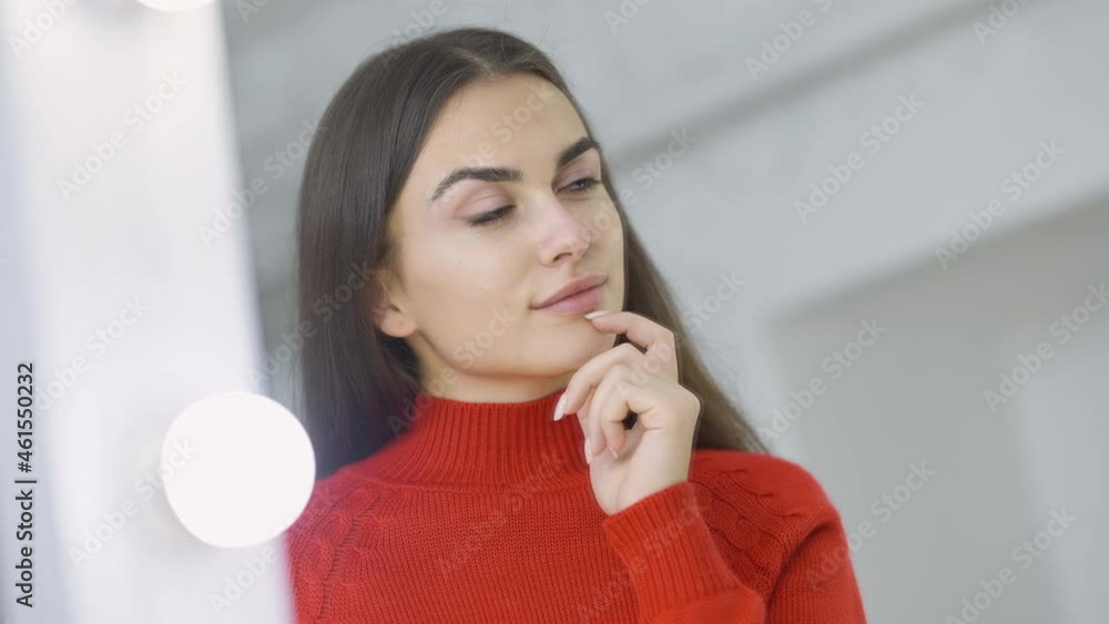 Close-up reflection of charming slim beautiful brunette woman with brown eyes looking at camera through mirror. Portrait of gorgeous Caucasian lady posing indoors in shop dressing room smiling Close-up reflection of charming slim beautiful brunette woman with brown eyes looking at camera through mirror. Portrait of gorgeous Caucasian lady posing indoors in shop dressing room smiling