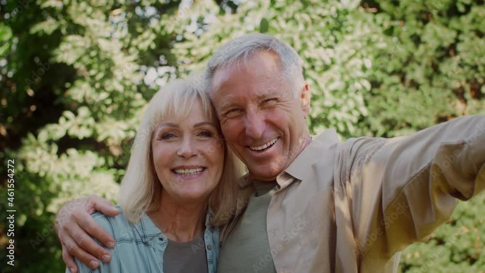 Happy Senior Couple Taking Selfie Outdoors, Looking At Camera And Smiling Happy Senior Couple Taking Selfie Outdoors, Looking At Camera And Smiling