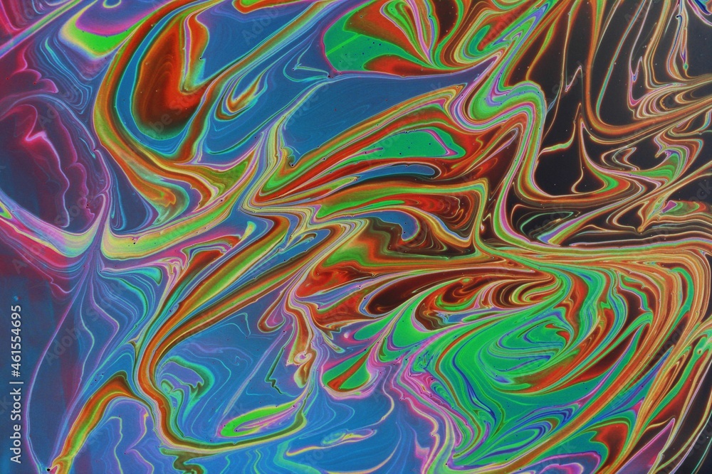 Obraz premium Abstract multicolored marble background. Acrylic paint mixes freely and creates an interesting pattern. Bright saturated shades. Background for the cover of a laptop, laptop.