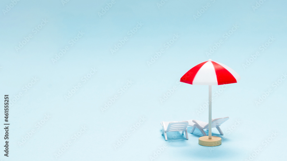 Travel concept. Sun lounger, red umbrella on a blue background. Travel concept. Sun lounger, red umbrella on a blue background.