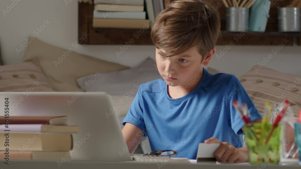 online shopping with credit card, student boy uses a computer at home, browses the internet looking for a purchase but is sad because he does not have enough credit card money, has to give up the game online shopping with credit card, student boy uses a computer at home, browses the internet looking for a purchase but is sad because he does not have enough credit card money, has to give up the game