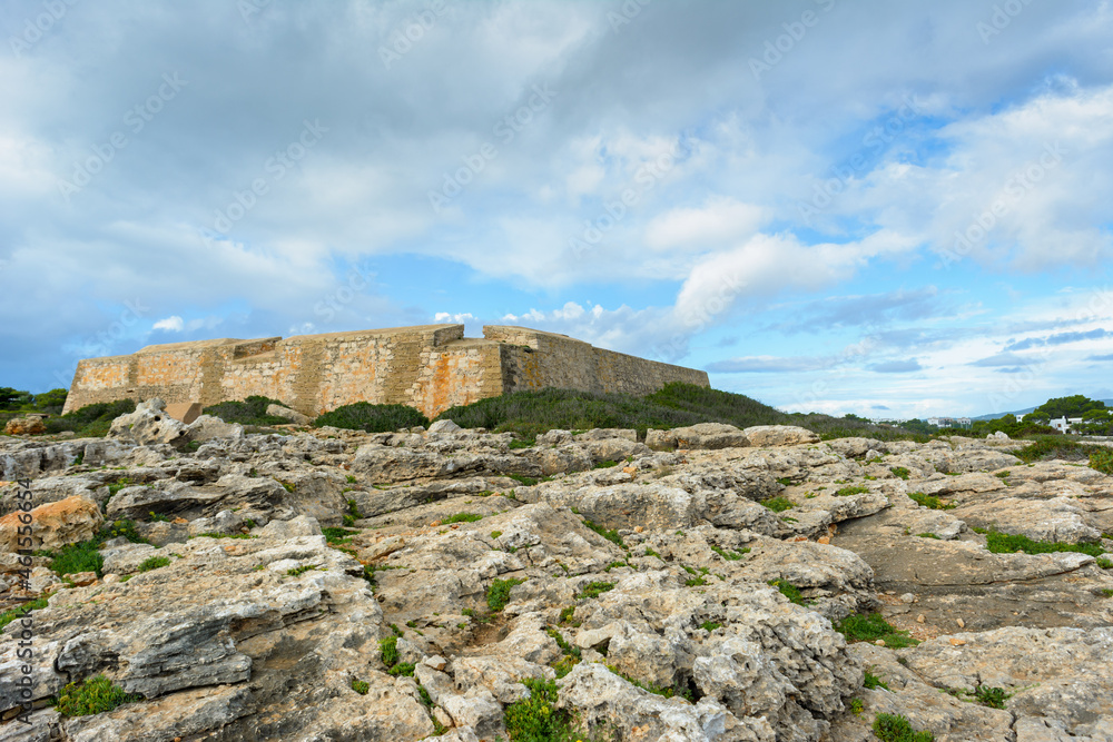 old coast fortress under cloudy blue sky