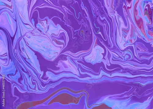 Abstract purple marble background. Acrylic paint mixes freely and creates an interesting pattern. Bright saturated shades. Background for the cover of a laptop, laptop.