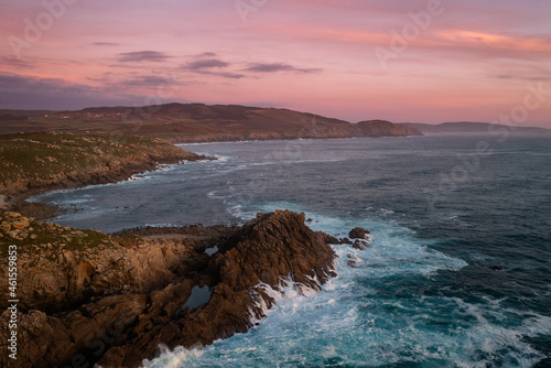 Cape Tourinan drone view at sunset with pink clouds, in Spain photo