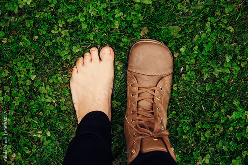 Person wearing barefoot boots shoes, which are wide, comfortable and healthy concept. Wide toe box fits all toes without compressing them together helps keep right body posture. photo