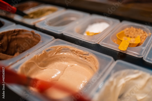 A photo of delicious cream chocolates in a modern patisserie. Selective focus