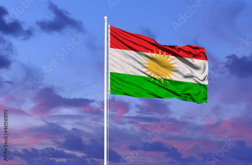 Beautiful national state flag of Kurdistan fluttering at sky background photo