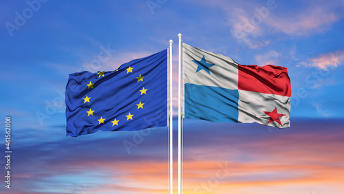 European Union and Panama two flags on flagpoles and blue cloudy sky