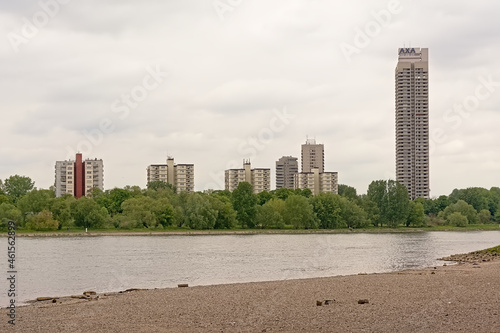 Skyscrapers along the borders of river Rhine in Cologne, view from the beach on the other side of the river. 