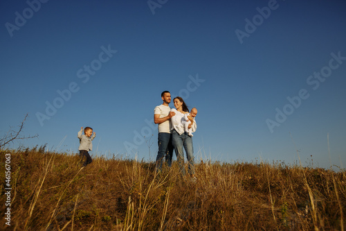 family with babies on a background of grass
