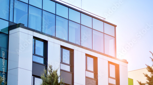 Corporate architecture building. New modern office building. Textured blue pane of contemporary glass architectural building. Sunlight.