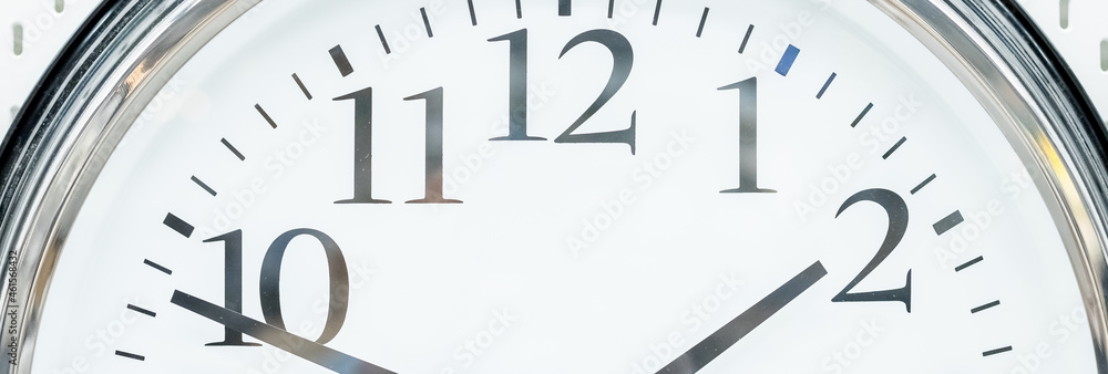 round clock with black arrows and numbers. big clock hanging on a wall. deadline,time management concept and lunch time,WAKE UP.web banner.