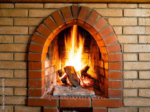 front view of brick fireplace with burning woods