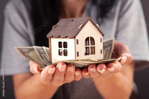 woman holding a house model