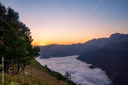 amazing sunrise in the ossau valley. magnificent sea of clouds in the valley. panoramic format shot