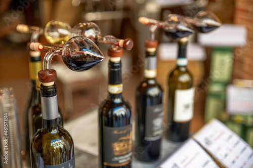 Montepulciano, Tuscany, Italy.August 2021. Close up shot of bottles with cruet for tasting in a typical local wine shop.