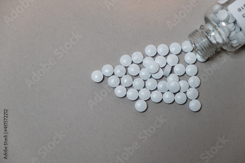 White tablet pills on a flat background with copy space. For advertising and health care messages