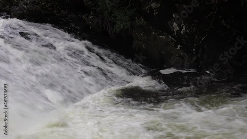 Water foaming, roaring and cascading through Rhaeadr Ewynnol Swallow Falls Waterfall, Snowdonia National Park, Swallow Falls, Betws-y-Coed LL24 0DW photo