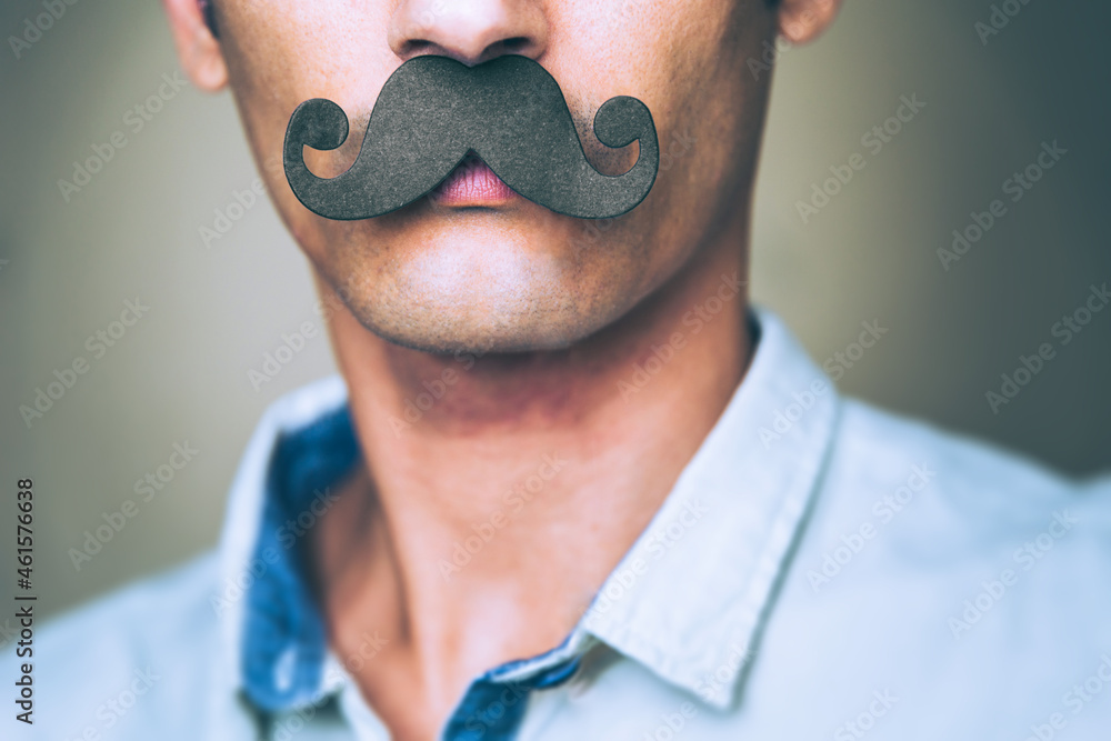 close up of a man's chin wearing a fake paper made mustache - Movember  - obrazy, fototapety, plakaty 