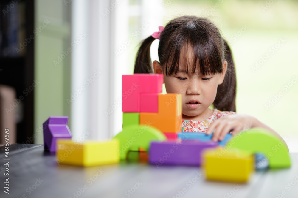 young girl playing toy blocks at home young girl playing toy blocks at home
