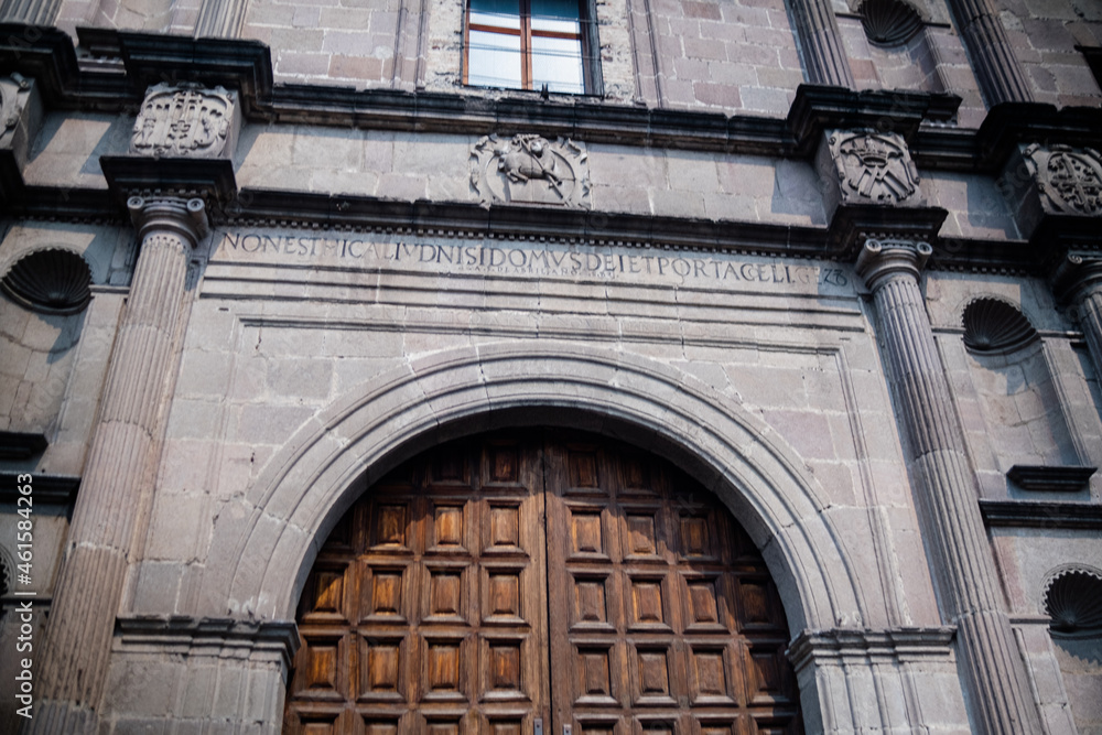 Big wooden doors and stone walls of old Mexican church