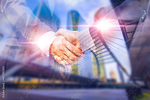 Double exposure picture.Picture mix building city and businessman is Shake hands show Confident.deal,partnership, Development,meeting,action.Picture concept teamwork man and business .
