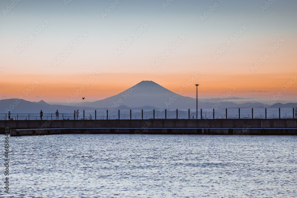 Obraz premium Mountain Fuji with skyline reflection and mist on water of lake Shoji Shojiko at sunrise, Yamanashi, Japan. Famous travel 5 lakes to see mount Fujisan.