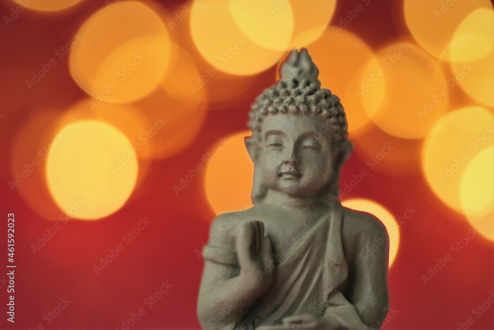 Buddha statue on red background with golden bokeh .Meditation and relaxation symbol.Buddhism religion Buddha statue on red background with golden bokeh .Meditation and relaxation symbol.Buddhism religion