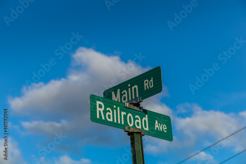 Main Rd and Railroad Ave street signs on an early fall evening