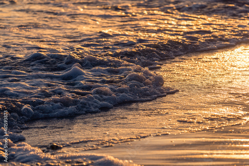 Waves foaming on sand