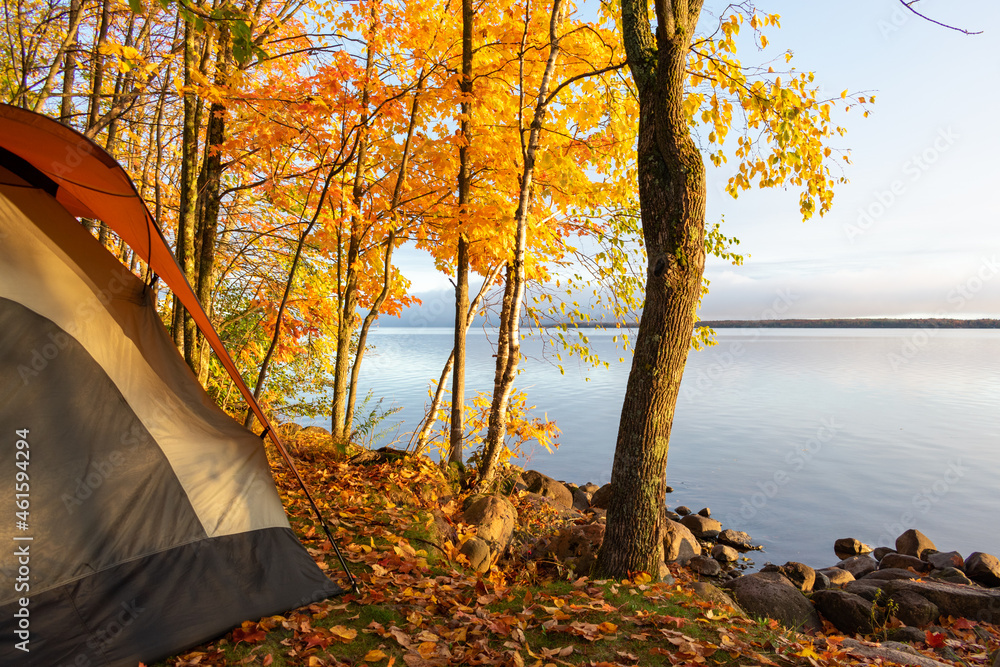 Waterside campsite in autumn with beautiful fall colors - obrazy, fototapety, plakaty 