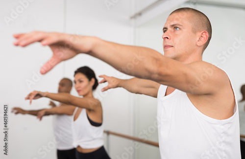 Man practicing ballet elements in dance class