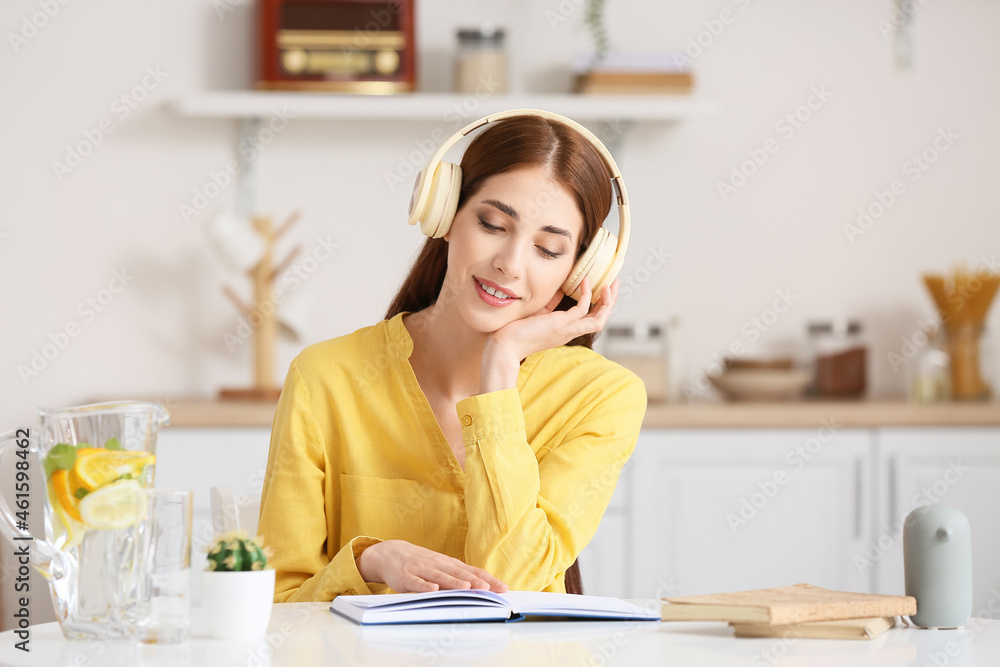 Young woman with headphones and book at home Young woman with headphones and book at home