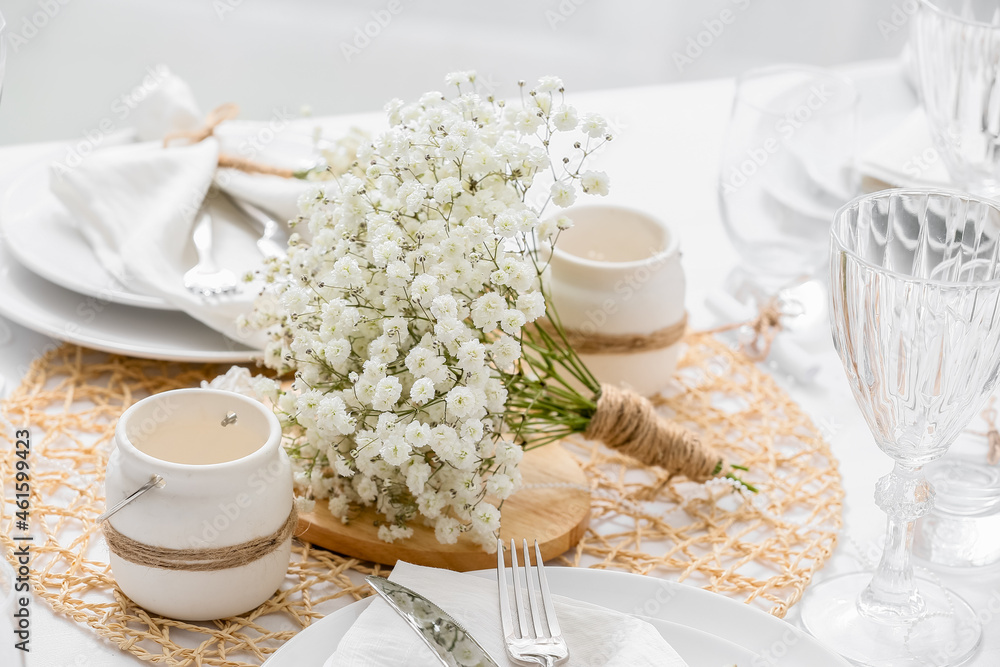Beautiful table setting with gypsophila flowers in restaurant