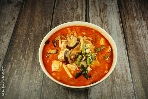 Traditional spicy red curry soup of tofu sheet mixed with chilly and string bean serving in the bowl. Famous vegetarian menu in Asia restaurant. 