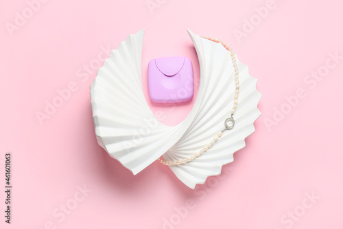 Tampons storage box and female necklace on pink background, top view © Pixel-Shot