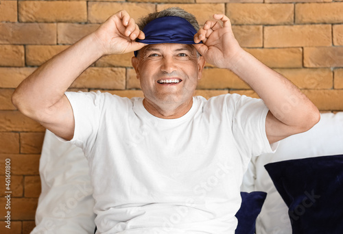Mature man with sleep mask ...