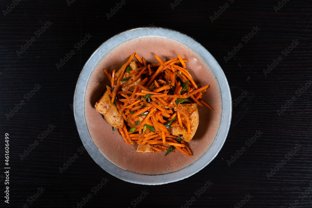 Grated carrot salad with chicken, chopped garlic chives and salad oil