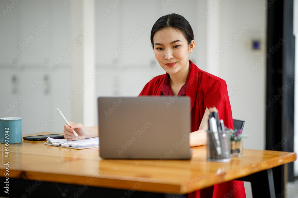 Professional young asian business woman using computer laptop and Talking On Phone Working On Laptop In Modern Office.
Professional young asian business woman using computer laptop and Talking On Phone Working On Laptop In Modern Office.