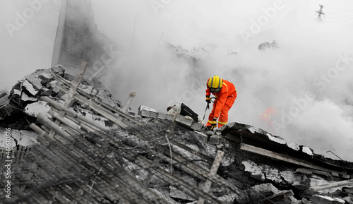 Search and rescue forces search through a destroyed building