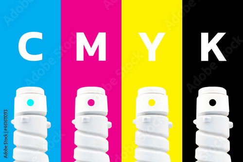 Photography Laser printer toner in a plastic bottle on a colorful background of CMYK (Cyan, magenta, yellow, Black) colors