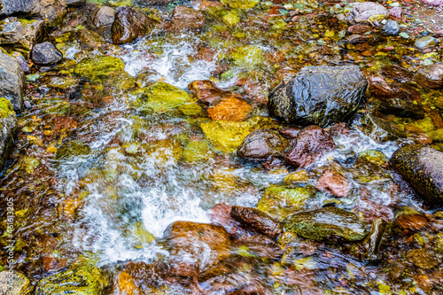 Snyder Creek Cascading Over Multicolored Stones  at Lake McDonald Lodge, Glacier National Park, Montana, USA photo