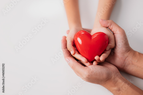 World heart day, world health day, CSR responsibility, adoption foster family, hope, gratitude, kind, concept, adult and child hands holding red heart, health care, donate and family insurance concept
