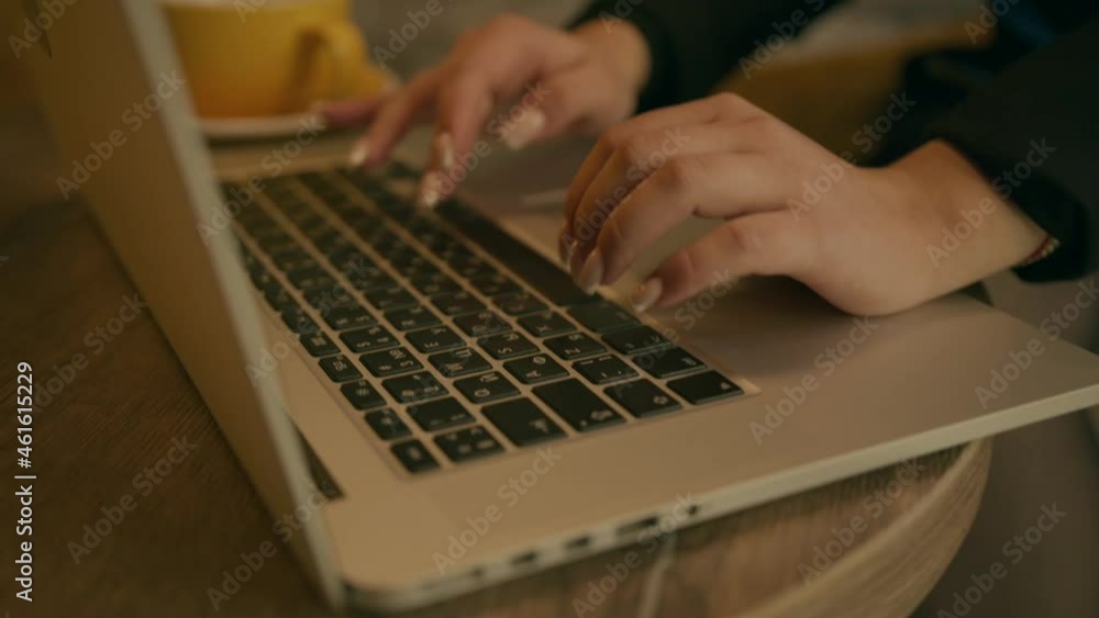 Close-up of a young girl's hand with a beautiful manicure typing on a laptop keyboard Close-up of a young girl's hand with a beautiful manicure typing on a laptop keyboard