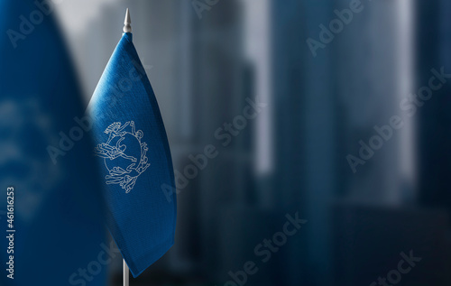 Small flags of Semeral Postal Union on a blurry background of the city