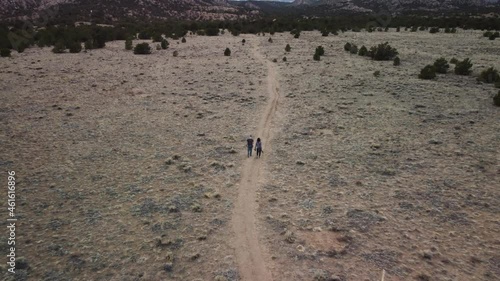 Couple walking on mountain trail towards Mount Shavano in Colorado, Aerial reveal photo