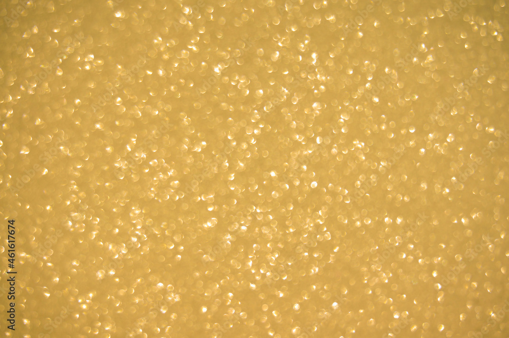 Gold glitters background. shimmering blur spot lights Bokeh Shiny gold light background.