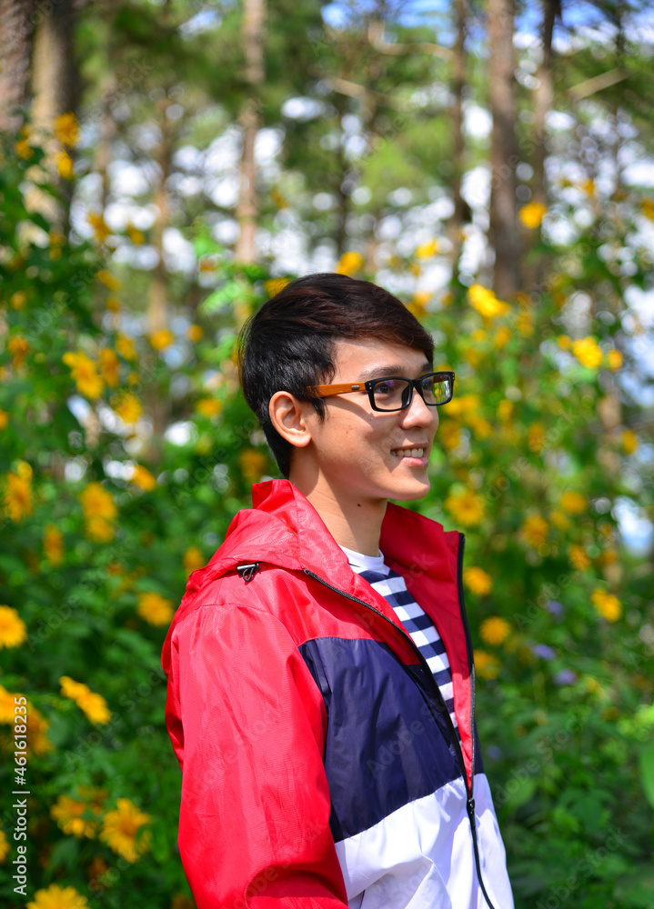 Young man enjoying at wild sunflower forest Young man enjoying at wild sunflower forest