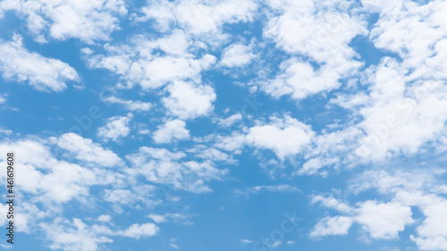 Blue sky background with white tiny clouds.